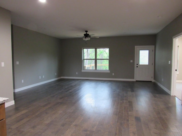 748 Birdsong Ln, Marshfield, MO 65706 - unfurnished living room featuring a ceiling fan, dark wood-style floors, and baseboards