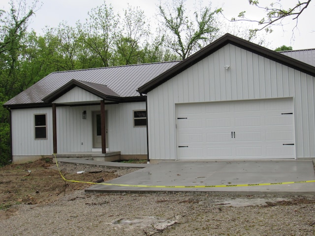 748 Birdsong Ln, Marshfield, MO 65706 - view of front of house with an attached garage, driveway, metal roof, and a porch