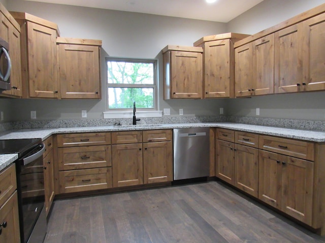 748 Birdsong Ln, Marshfield, MO 65706 - kitchen with stainless steel appliances, dark wood-style flooring, a sink, light stone counters, and brown cabinets
