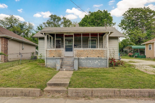 view of front of home featuring stone siding, a front lawn, entry steps, and dirt driveway