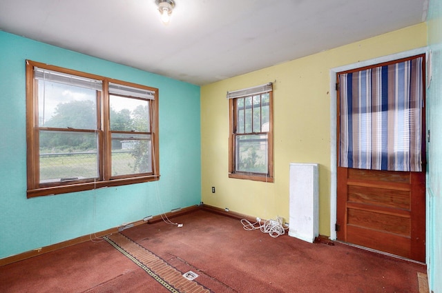 carpeted spare room with baseboards
