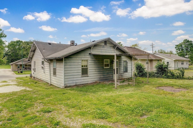 rear view of house with a shingled roof