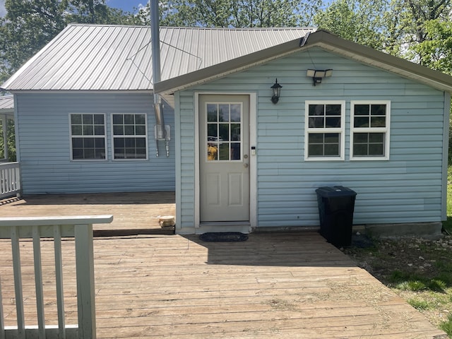 rear view of property featuring a wooden deck