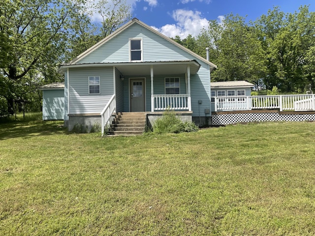bungalow-style home featuring covered porch and a front yard