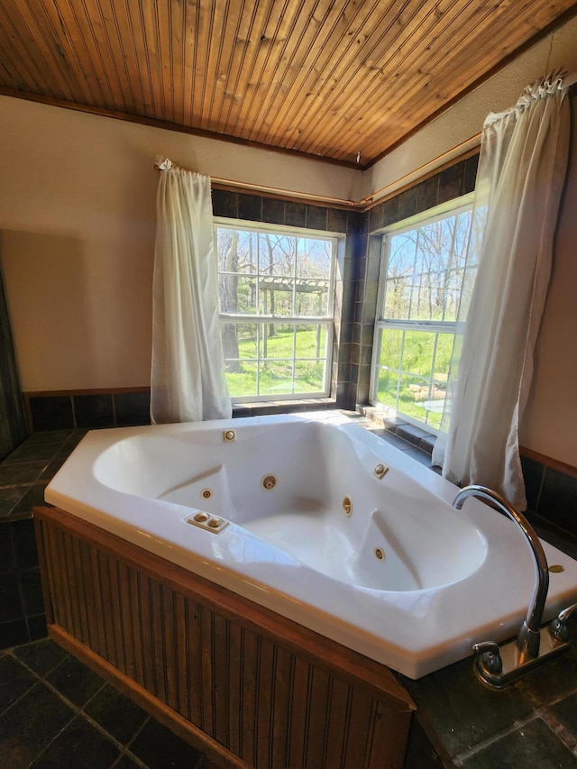 bathroom with a jetted tub, tile patterned flooring, and wood ceiling