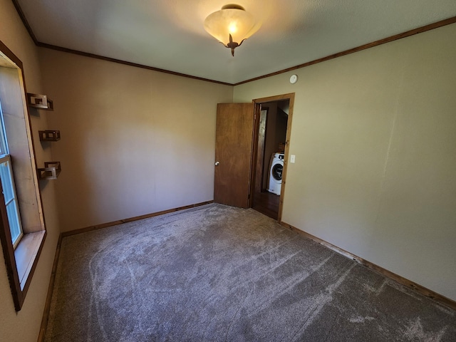 carpeted empty room with crown molding, washer / clothes dryer, and baseboards