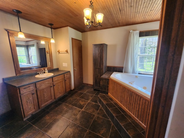 full bathroom featuring plenty of natural light, tile patterned flooring, a tub with jets, a chandelier, and ornamental molding