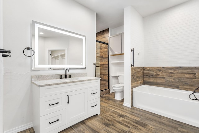 1970 Pointe Royale Dr, Branson, MO 65616 - bathroom featuring toilet, vanity, wood finished floors, and a bath