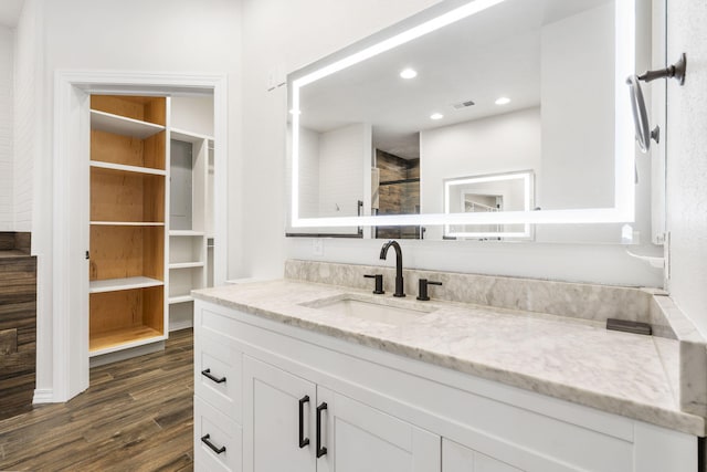 1970 Pointe Royale Dr, Branson, MO 65616 - full bathroom with wood finished floors, vanity, a tile shower, and recessed lighting