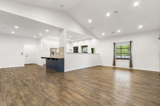 1970 Pointe Royale Dr, Branson, MO 65616 - unfurnished living room with dark wood-type flooring, recessed lighting, baseboards, and high vaulted ceiling