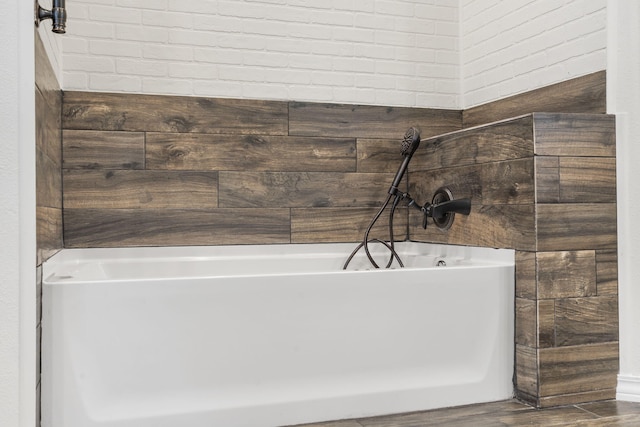 1970 Pointe Royale Dr, Branson, MO 65616 - full bathroom featuring a soaking tub and wood finished floors