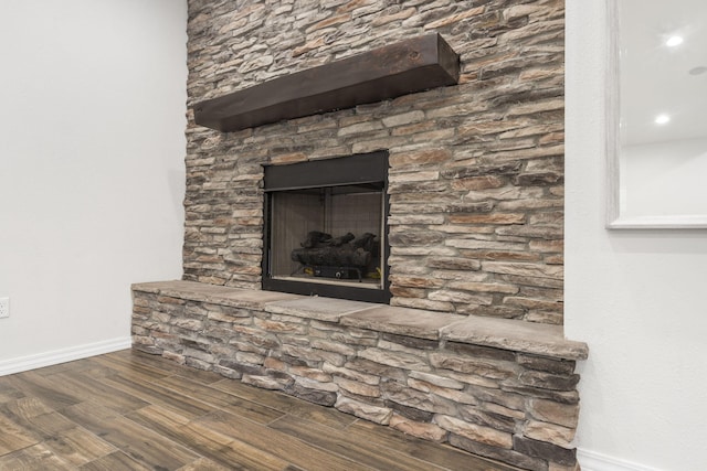 1970 Pointe Royale Dr, Branson, MO 65616 - detailed view of wood finished floors, baseboards, and a stone fireplace