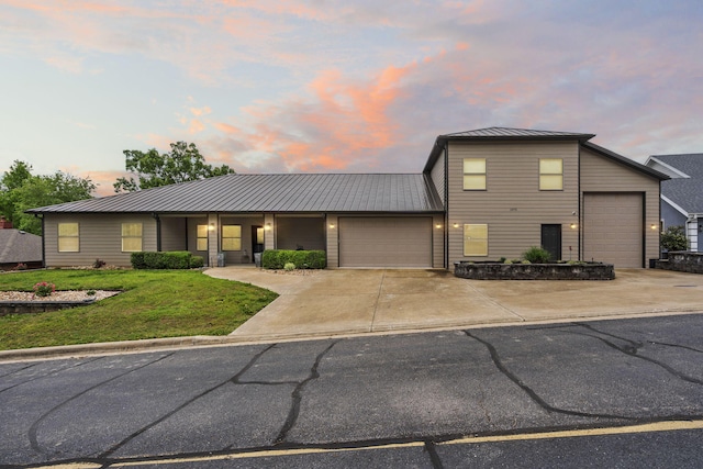 1970 Pointe Royale Dr, Branson, MO 65616 - view of front of home with a garage, a yard, concrete driveway, metal roof, and a standing seam roof