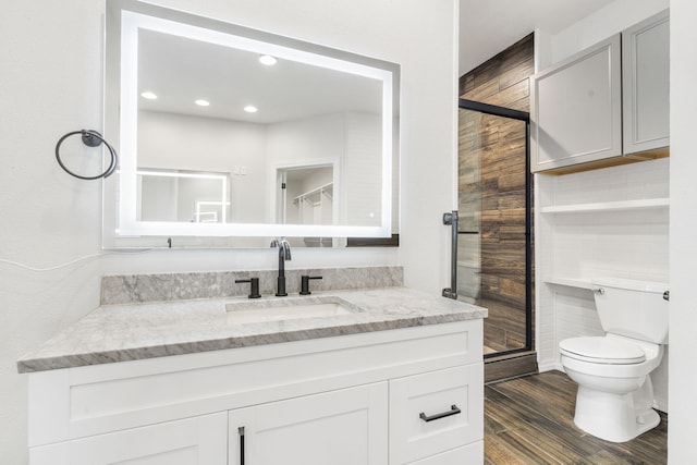 1970 Pointe Royale Dr, Branson, MO 65616 - bathroom with toilet, a shower stall, wood finished floors, vanity, and recessed lighting