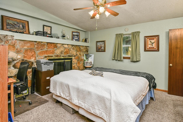 carpeted bedroom featuring lofted ceiling, a textured ceiling, and a ceiling fan
