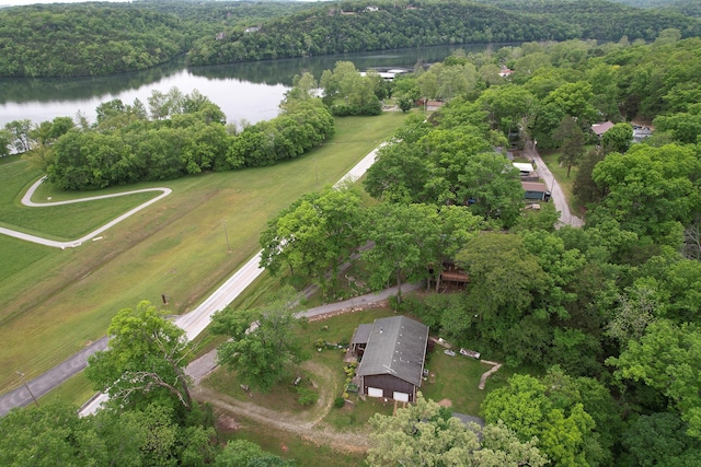 aerial view of property's location with a nearby body of water and a forest