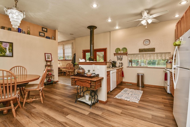 kitchen with white appliances, ceiling fan, recessed lighting, a sink, and light countertops