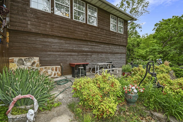 view of side of home featuring stone siding