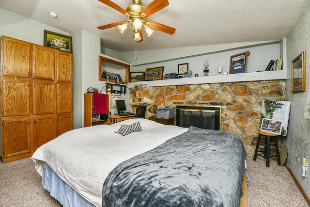 bedroom with light colored carpet, a textured ceiling, lofted ceiling, and a ceiling fan