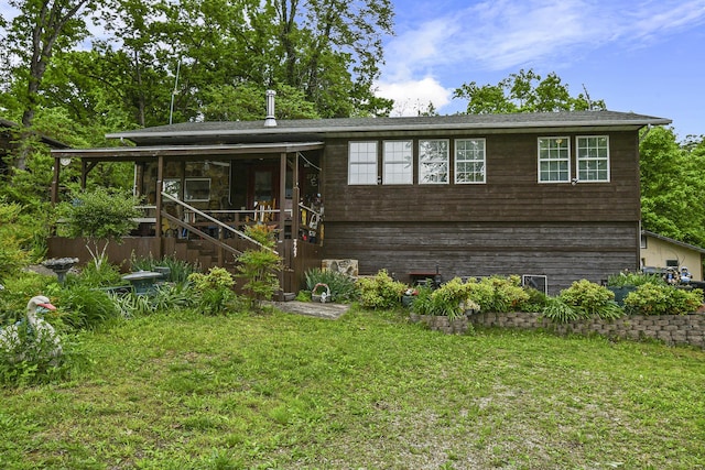 view of front facade with a front lawn and stairs