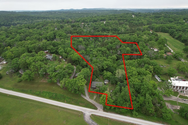 aerial overview of property's location featuring a heavily wooded area and property boundaries highlighted