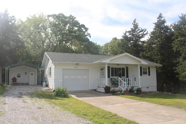 23197 Oakwood Cir, Hermitage, MO 65668 - ranch-style home with a detached carport, a porch, driveway, crawl space, and an attached garage