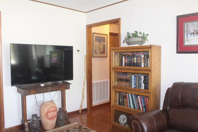 23197 Oakwood Cir, Hermitage, MO 65668 - living area with wood finished floors, ornamental molding, and baseboards