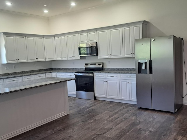 137 Vista Ln, Granby, MO 64844 - kitchen with appliances with stainless steel finishes, dark wood finished floors, dark stone counters, recessed lighting, and white cabinets
