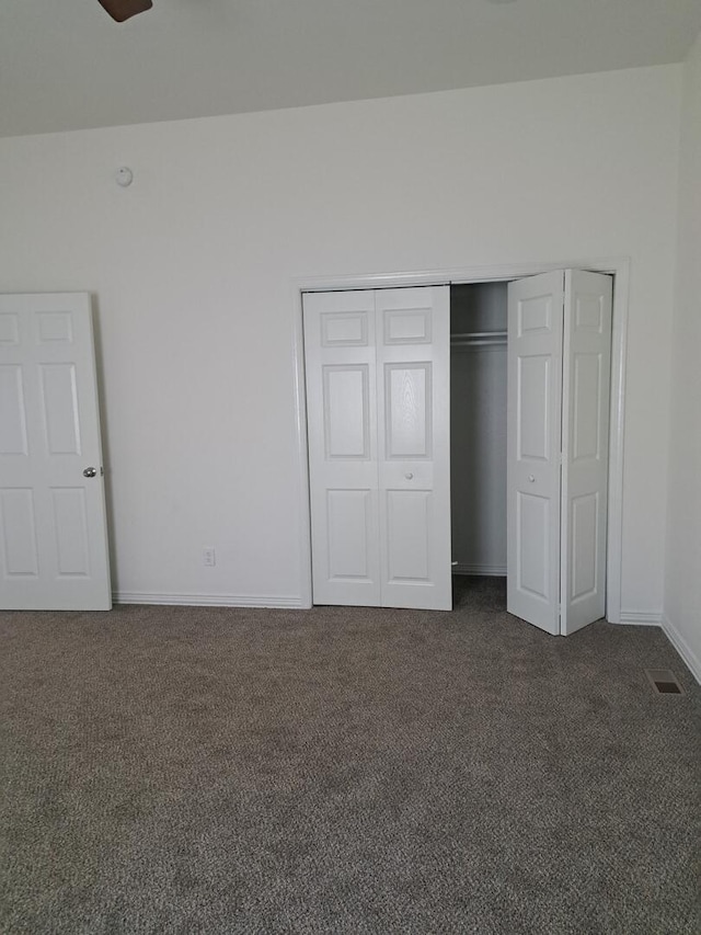 137 Vista Ln, Granby, MO 64844 - unfurnished bedroom featuring dark carpet, a closet, and baseboards