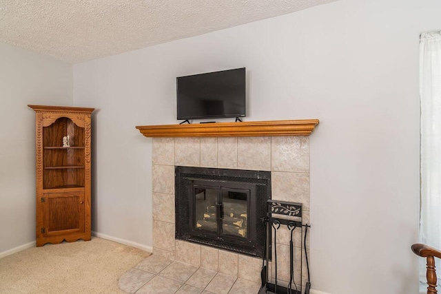 detailed view of a tiled fireplace, baseboards, carpet floors, and a textured ceiling