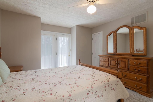 bedroom featuring a textured ceiling, carpet floors, a ceiling fan, and access to exterior