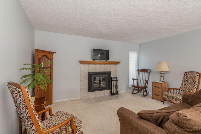 carpeted living area featuring a fireplace and a textured ceiling