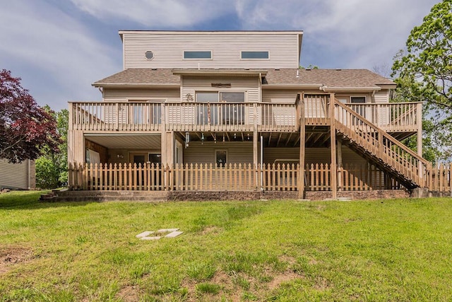 back of property with a wooden deck, a shingled roof, and stairway