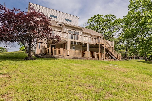 back of property with a deck, stairway, and a lawn