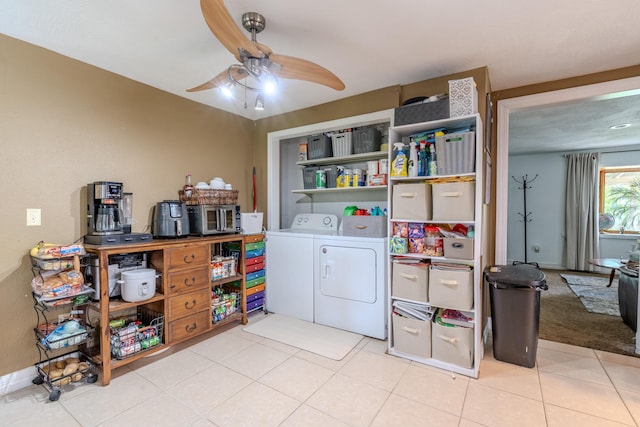 washroom with washer and clothes dryer, a ceiling fan, and light tile patterned floors
