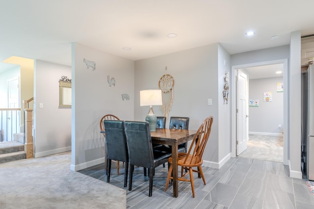 dining room featuring baseboards, stairs, and recessed lighting