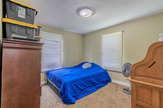 bedroom with carpet and baseboards