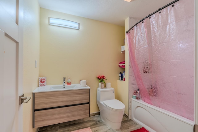 bathroom featuring wood finished floors, vanity, toilet, and shower / tub combo