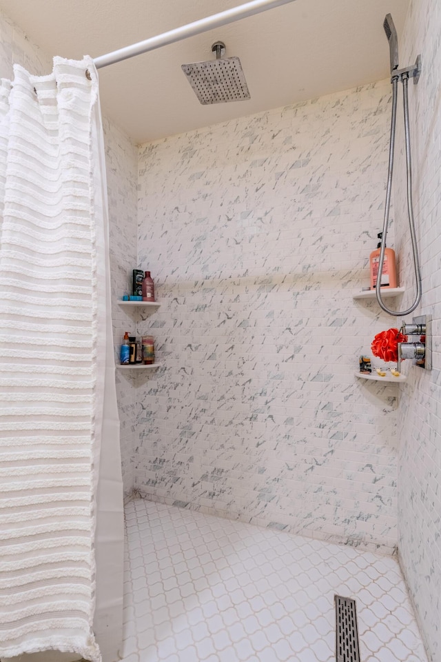 full bathroom with curtained shower and tile patterned flooring