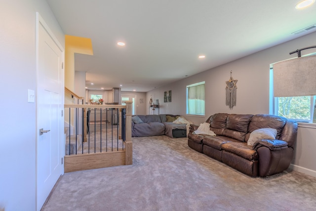 carpeted living room featuring recessed lighting and stairs