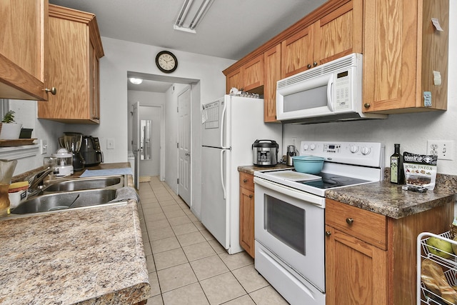 1292 Hillcrest Pl Unit A & B, Branson, MO 65616 - kitchen with white appliances, a sink, light tile patterned flooring, and brown cabinets