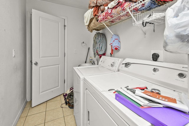 1292 Hillcrest Pl Unit A & B, Branson, MO 65616 - laundry area featuring washer and dryer, light tile patterned flooring, and baseboards
