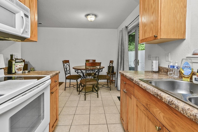 1292 Hillcrest Pl Unit A & B, Branson, MO 65616 - kitchen featuring white appliances, light tile patterned floors, brown cabinetry, and a sink
