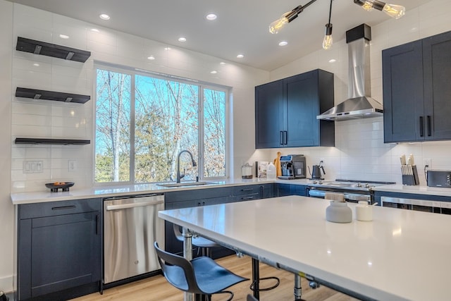 139 Cherokee Dr, Kimberling City, MO 65686 - kitchen featuring stainless steel appliances, a sink, wall chimney range hood, light countertops, and backsplash
