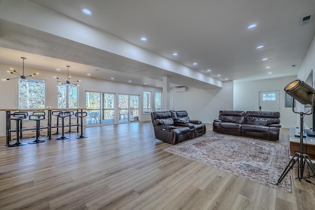 139 Cherokee Dr, Kimberling City, MO 65686 - living room with wood finished floors, a chandelier, recessed lighting, a wall unit AC, and baseboards