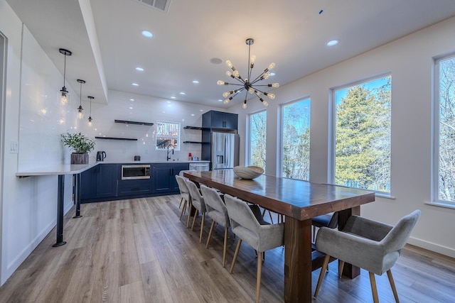 139 Cherokee Dr, Kimberling City, MO 65686 - dining room with a chandelier, light wood-type flooring, healthy amount of natural light, recessed lighting, and baseboards