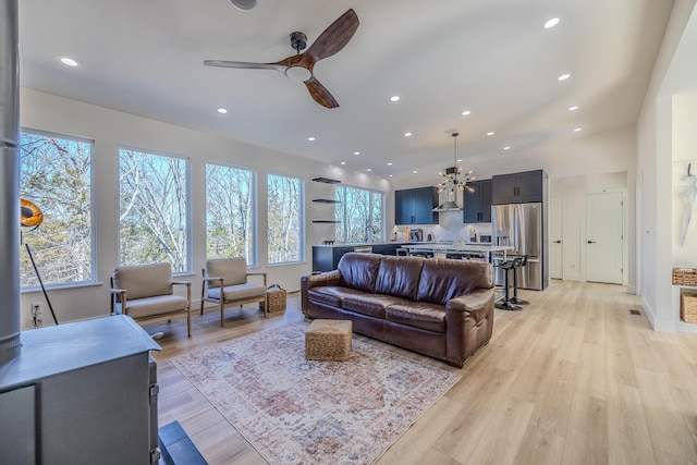 139 Cherokee Dr, Kimberling City, MO 65686 - living room featuring recessed lighting, a ceiling fan, light wood-type flooring, and a chandelier
