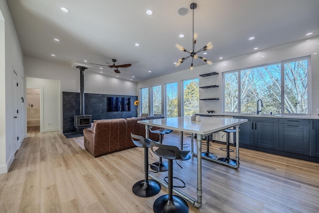 139 Cherokee Dr, Kimberling City, MO 65686 - kitchen with a wood stove, a sink, dishwashing machine, light wood-type flooring, and recessed lighting