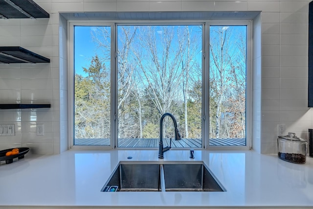 139 Cherokee Dr, Kimberling City, MO 65686 - kitchen featuring a sink, healthy amount of natural light, decorative backsplash, and tile walls
