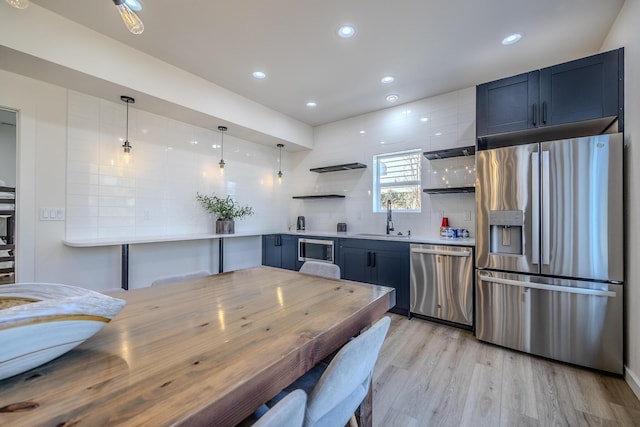 139 Cherokee Dr, Kimberling City, MO 65686 - kitchen featuring stainless steel appliances, a sink, open shelves, backsplash, and light countertops